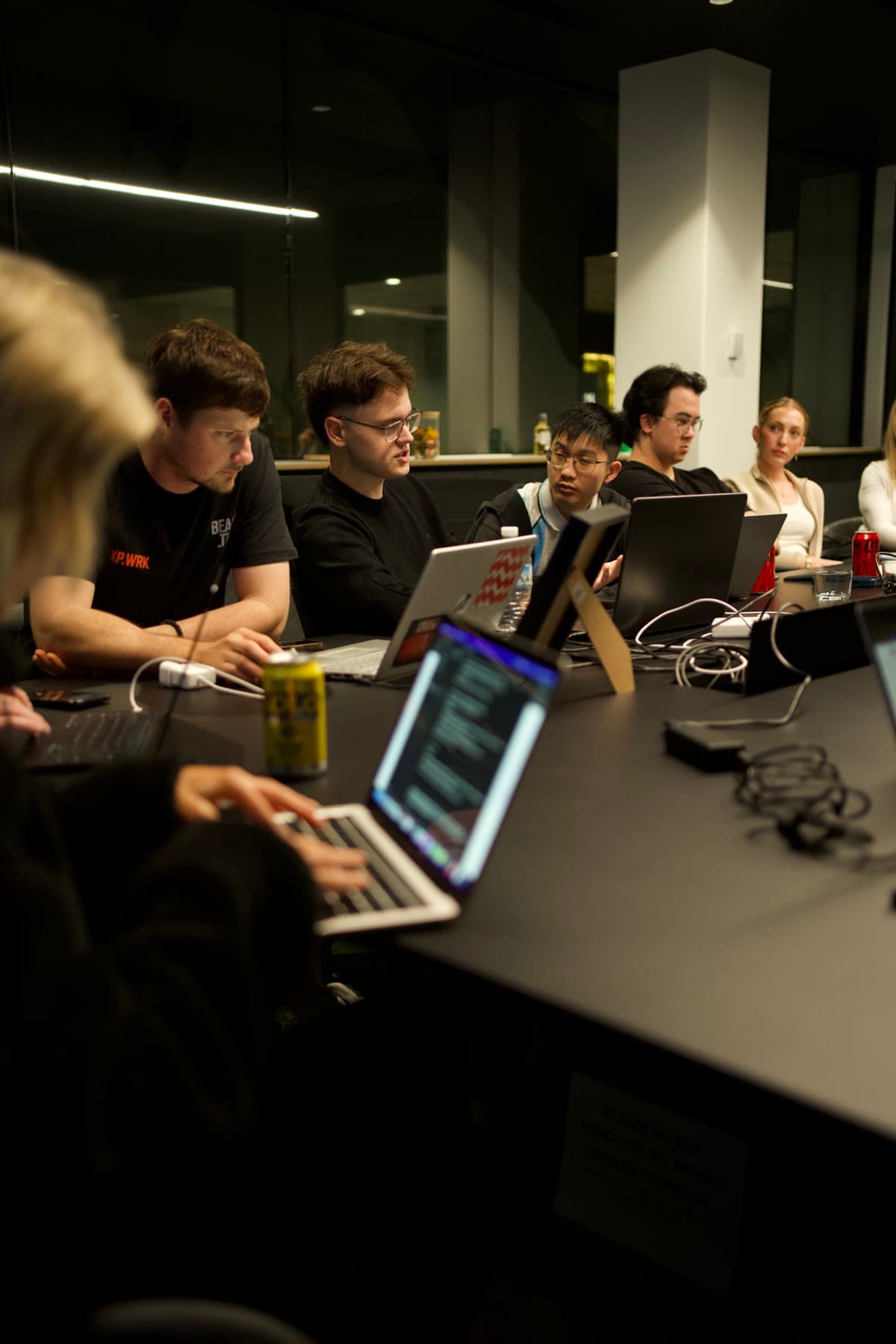 Hands-on at the table, laptops open